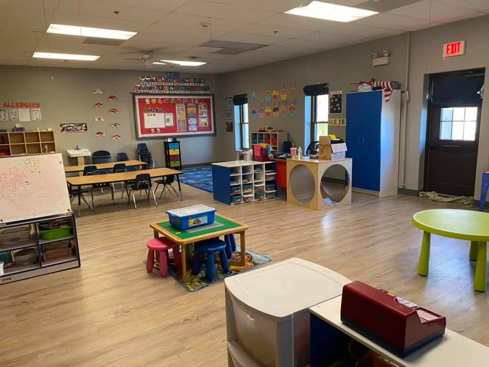 Pre-K Room with learning centers, child-sized tables, classroom displays, and open activity space